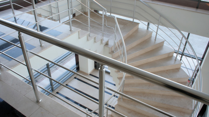 Marble staircase in an office with steel railing